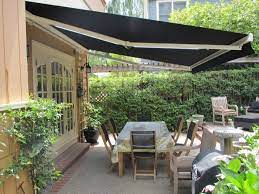 house with solar screens installed above the garage on a sunny day