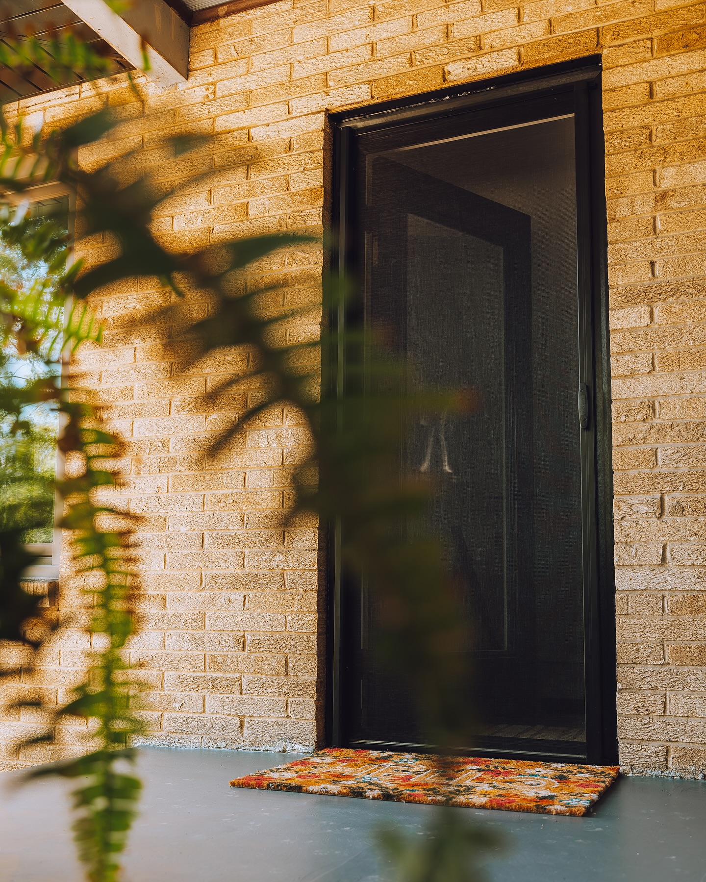 Person in white opening sliding screen door